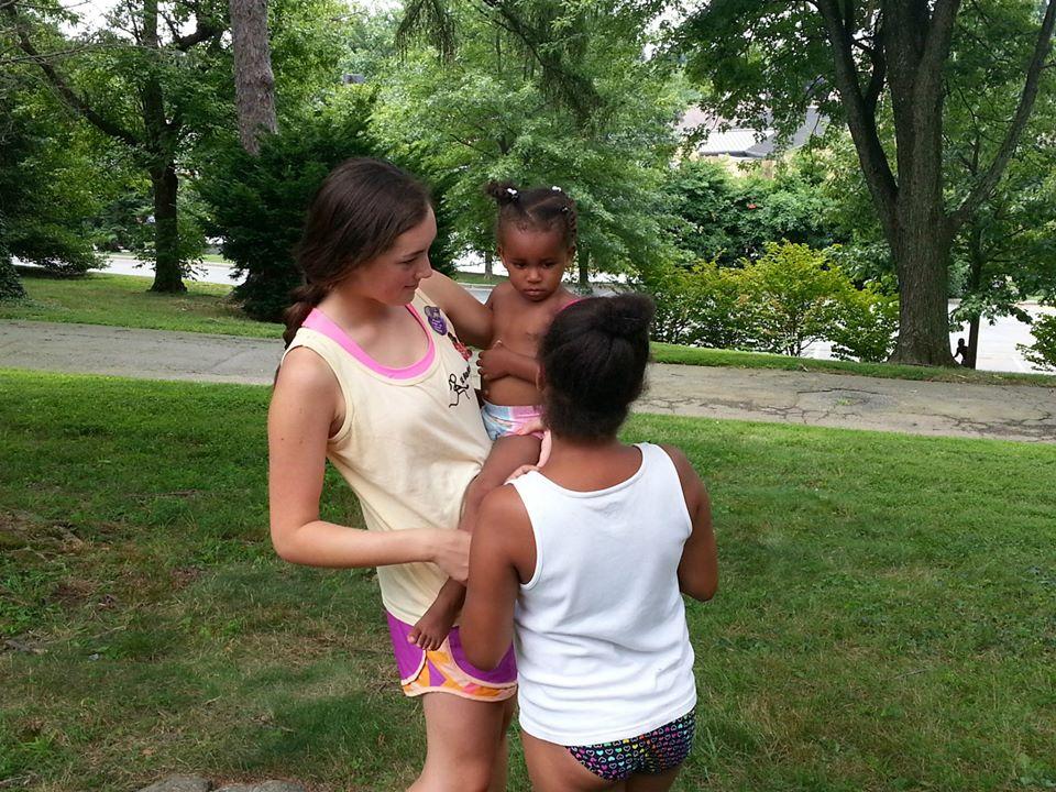 Grace Macatee is holding one of the kids at camp in her arms. The kids were always begging to be held. 