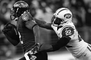 New York Jet Ed Reed tackles Baltimore Raven wide receiver Jacoby Jones. Ed Reed was released from the Ravens after their Super Bowl win and was picked up by the Texans only to be released again. Ed Reed is now a safety for the Jets. 