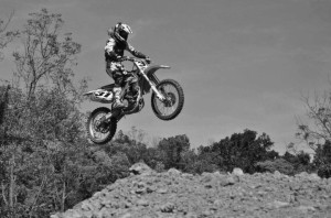 Sophomore Annie Wernig completes a jump during one of her usual motocross races. Both Wernig have been racing for more than eight years and both have plans to go pro one day.  