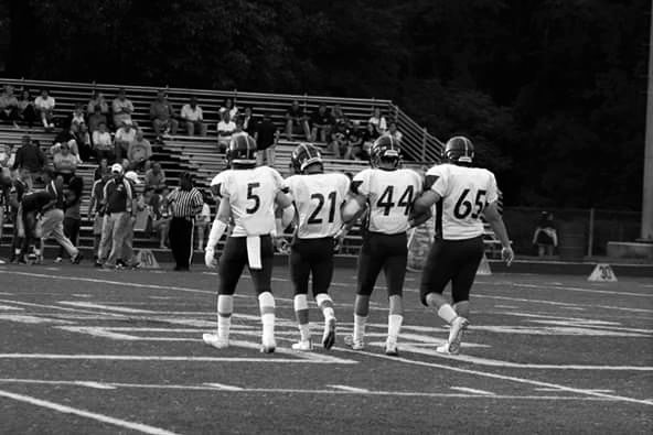 Captains Cole Dickerson, Sean Feiss, JT Kidd, and Erik Beyer walk out to the coin toss before the start of the game.