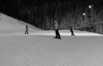 Grace Conklin and friends going down a slope snowboarding. Grace enjoys going snowboarding at Whitetail Resort. 