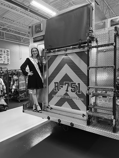 Senior Abbey Huneke standing on Jarrettsville Volunteer Fire Companys engine as Miss Fire Prevention. Huneke was elected back in Nov. 2021 to become Miss and has taken on the responsibility since.
