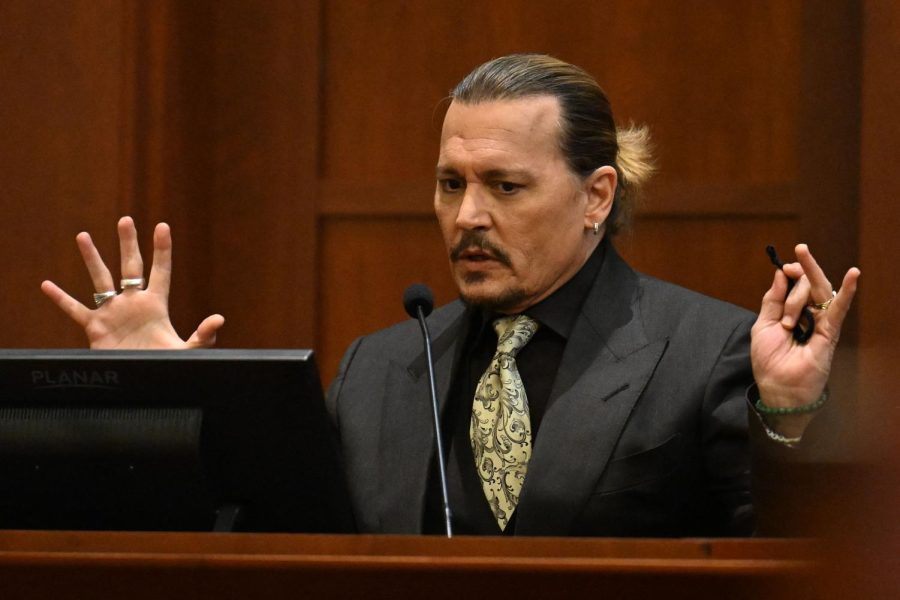 Johnny Depp on the stand during his defamation trial against his ex wife Amber Heard. The trial is expected to continue for at least another week as of May 10. PHOTO CREDIT: Jim Watson, Getty Images
