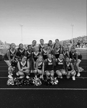           Cheerleading posed for a picture after the first home game. The team are cheering for the rest of the season at home football games.

