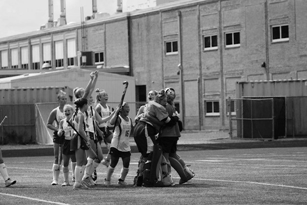 Part of the girls field hockey team celebrating after a win. The team is going forward to play many other schools and keep their winning streak alive. PHOTO CREDITS: Kaley Mullhausen
